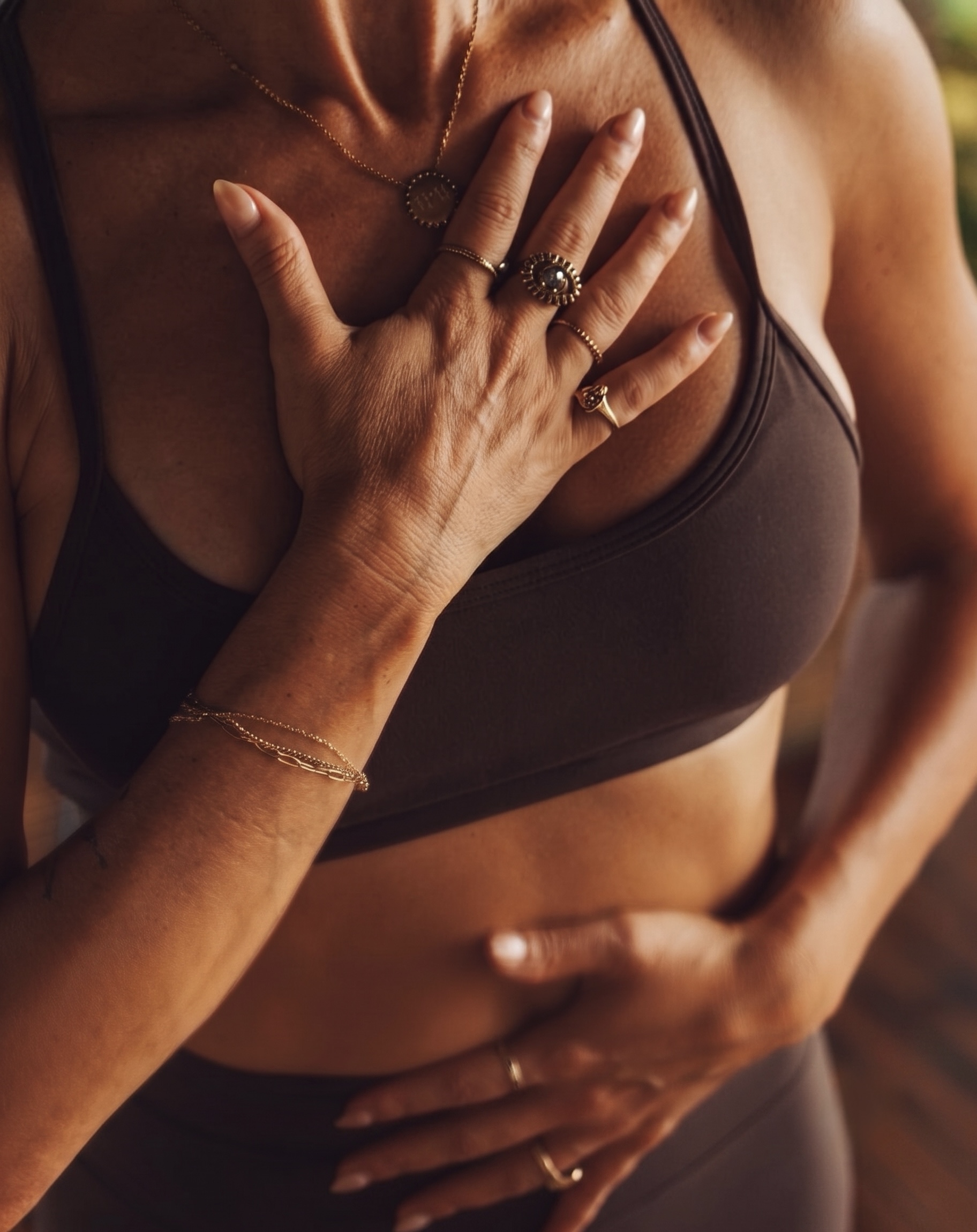 A woman's hands resting on her chest and belly as she breathes